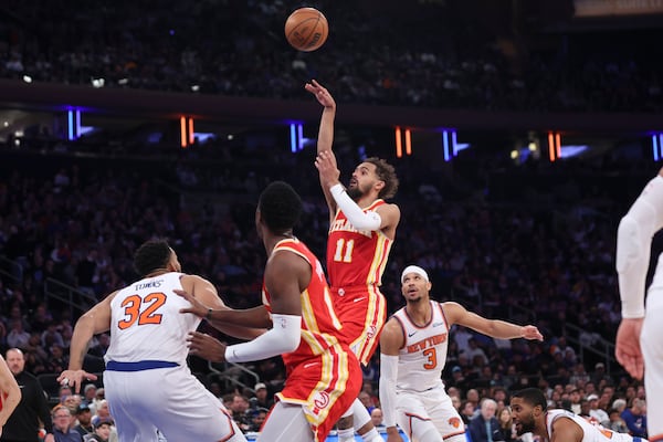 Hawks star Trae Young shoots over defenders during Monday's loss to the Knicks.