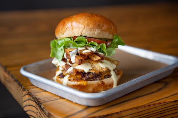 The burger known as the Sink at LR Burger includes fried egg, cheddar cheese, fries, jalapeno, lettuce, tomato, onion and fry sauce. Courtesy of Damian AhChing/Local Restaurant Group