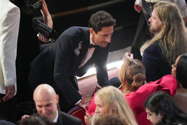 Adrien Brody greets Queen Latifah during the Oscars on Sunday, March 2, 2025, at the Dolby Theatre in Los Angeles. (AP Photo/Chris Pizzello)