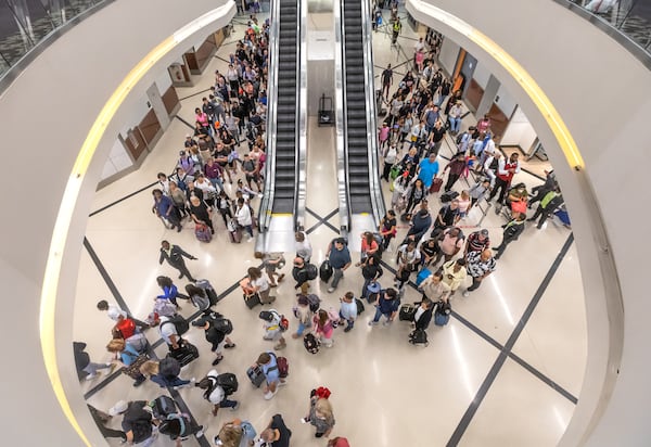 File photo of Hartsfield-Jackson International Airport domestic terminal on July 22, 2024. Public health experts say now is a good time to use extra precautions such as wearing a mask in crowded places including airports during this summer COVID wave. (John Spink/AJC)