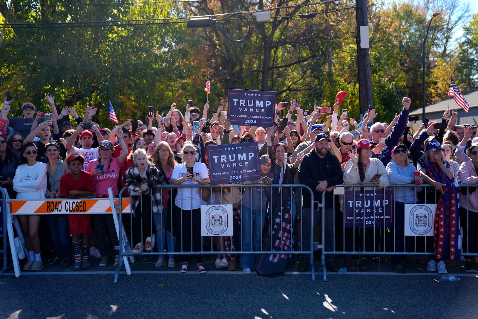 Supporters of Republican presidential nominee former President Donald Trump cheer outside of a McDonald's in Feasterville-Trevose, Pa., after Trump made a campaign stop, Sunday, Oct. 20, 2024, (AP Photo/Evan Vucci)