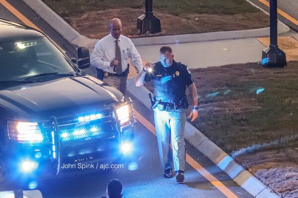 Cobb police look for evidence after an officer-involved shooting at the Walton on the Chattahoochee apartment complex Friday morning. JOHN SPINK / JSPINK@AJC.COM