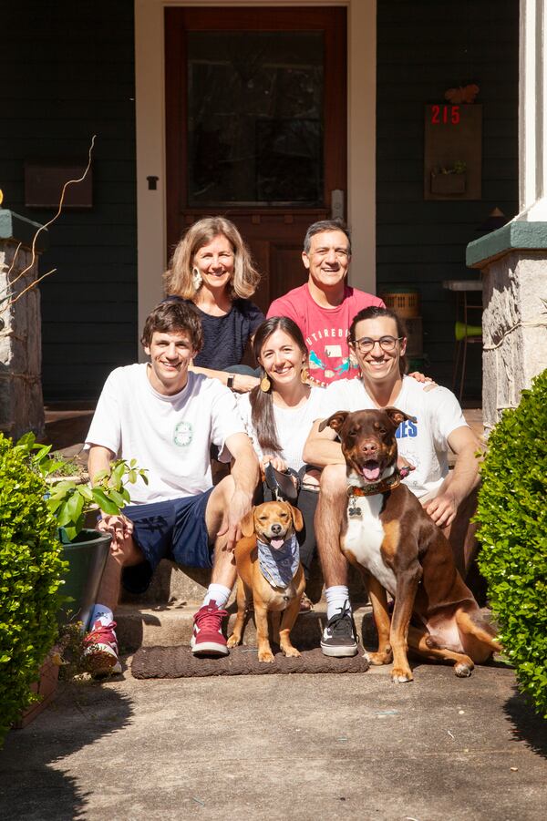 Saleem and Lisa Malik purchased their Inman Park American Foursquare in 2014. Their children are (left to right) Hobie, 21, Campbell, 26, and Jason, 23, with dogs Wally (left) and Lewis (right). Lisa is a speech-language pathologist and Saleem is an obstetrician/gynecologist.