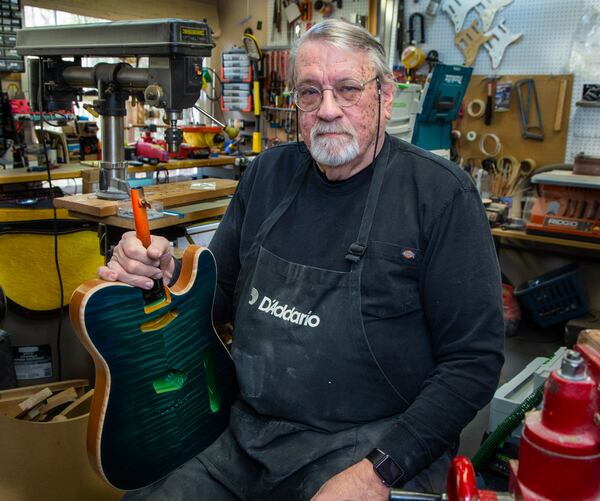 Portrait of Bud Veazey with one of his custom guitars in the basement workshop of his Lawrenceville home. He recently gave an electric guitar to a victim of the Nashville bombing who collection of guitars were destroyed. PHIL SKINNER FOR THE ATLANTA JOURNAL-CONSTITUTION.