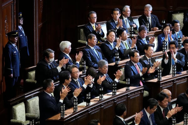 Lawmakers applaud as Japanese Prime Minister Shigeru Ishiba, top center, was elected for a new prime minister at a special parliamentary session of the lower house Monday, Nov. 11, 2024, in Tokyo. (AP Photo/Eugene Hoshiko)