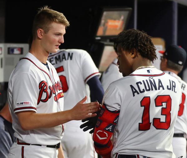 Braves pitcher Mike Soroka (left) shakes hands with Ronald Acuna Jr. after going seven innings against the St. Louis Cardinals.  Curtis Compton/ccompton@ajc.com