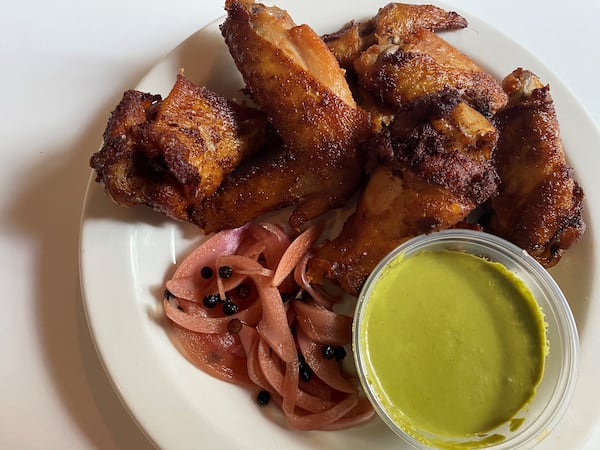 Seven Lamps offers wings that are smoked, then fried, with pickled red onion, cilantro and aji verde. CONTRIBUTED BY BOB TOWNSEND
