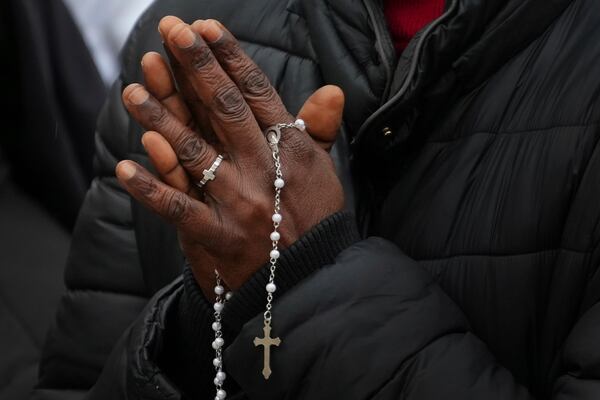 A nun holds rosary beads as people pray for Pope Francis in front of the Agostino Gemelli Polyclinic, where the Pontiff has been hospitalized since Feb.14, in Rome, Saturday, March 1, 2025. (AP Photo/Kirsty Wigglesworth)