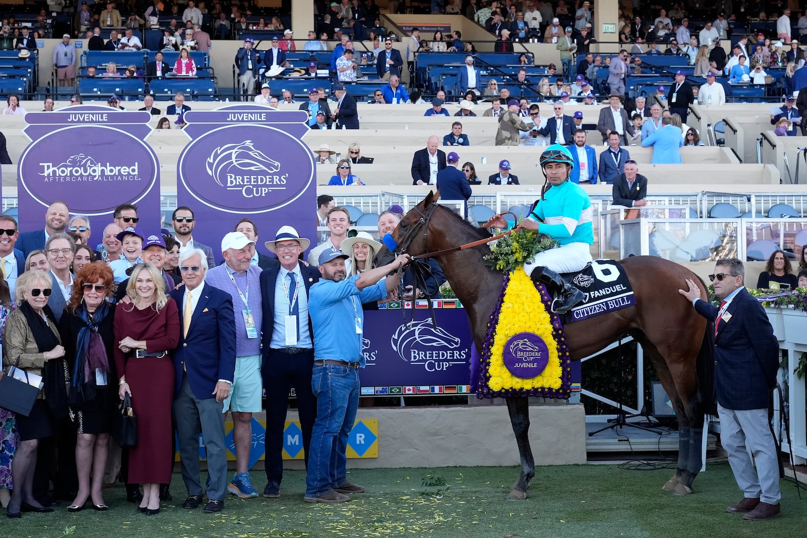 Martin Garcia, middle right, celebrates after riding Citizen Bull to victory in the Breeders' Cup Juvenile horse race at Santa Anita Park in Del Mar, Calif., Friday, Nov. 1, 2024. (AP Photo/Gregory Bull)