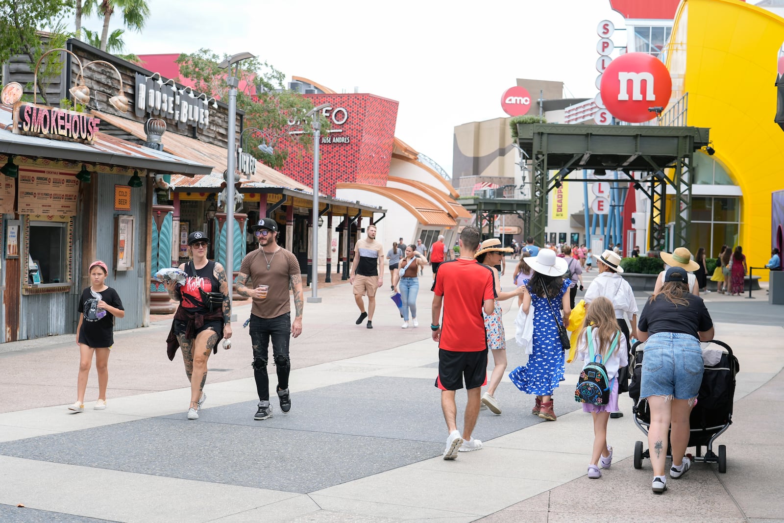 Calm weather greets tourists strolling past the various shops at the Disney Springs entertainment complex as Hurricane Milton threatens Florida, Tuesday, Oct. 8, 2024, in Lake Buena Vista, Fla. (AP Photo/John Raoux)