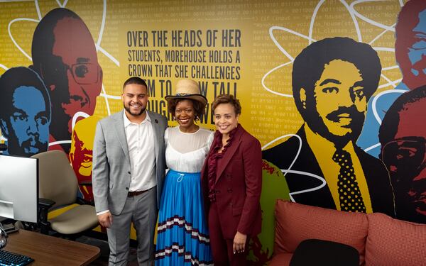 Ernest Holmes (left), Shanequa Gay (center) and Melonie Parker (right) pose in front of Gay's mural in the new Morehouse College Google Annex classroom at Charles Merrill Hall on Monday, May 13, 2024. (Ben Hendren for The Atlanta Journal-Constitution)