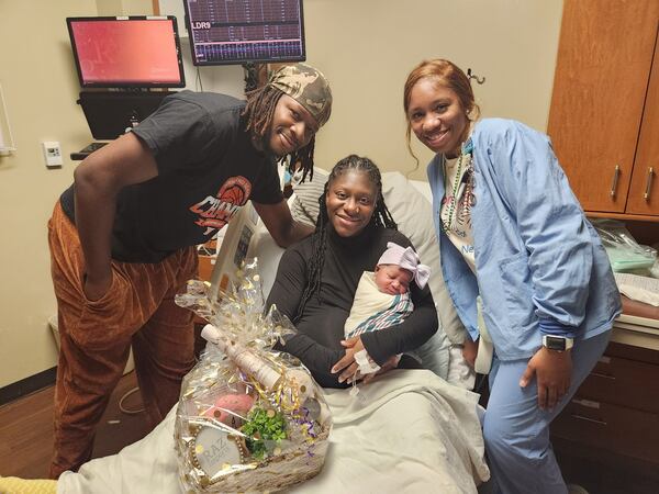 Jade Johnson was the first baby born in 2025 at Piedmont Fayette Hospital. She arrived at 2:07 a.m. to mom Jordan Johnson and dad Mark Mitchell (left). Delivery nurse D'Ashley Trammell (right) assisted with the birth. (Courtesy of Piedmont Fayette Hospital)