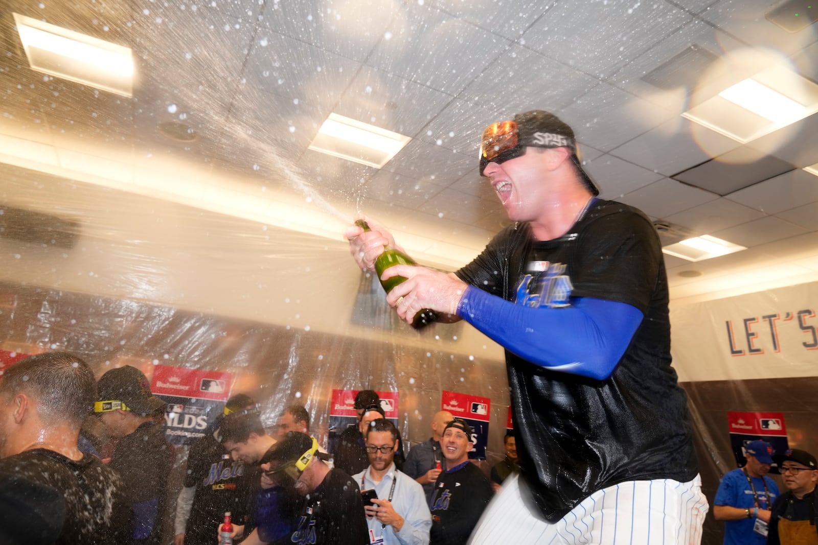 New York Mets' Pete Alonso celebrates in the locker room after defeating the Philadelphia Phillies in Game 4 of the National League baseball playoff series, Wednesday, Oct. 9, 2024, in New York. (AP Photo/Frank Franklin II)