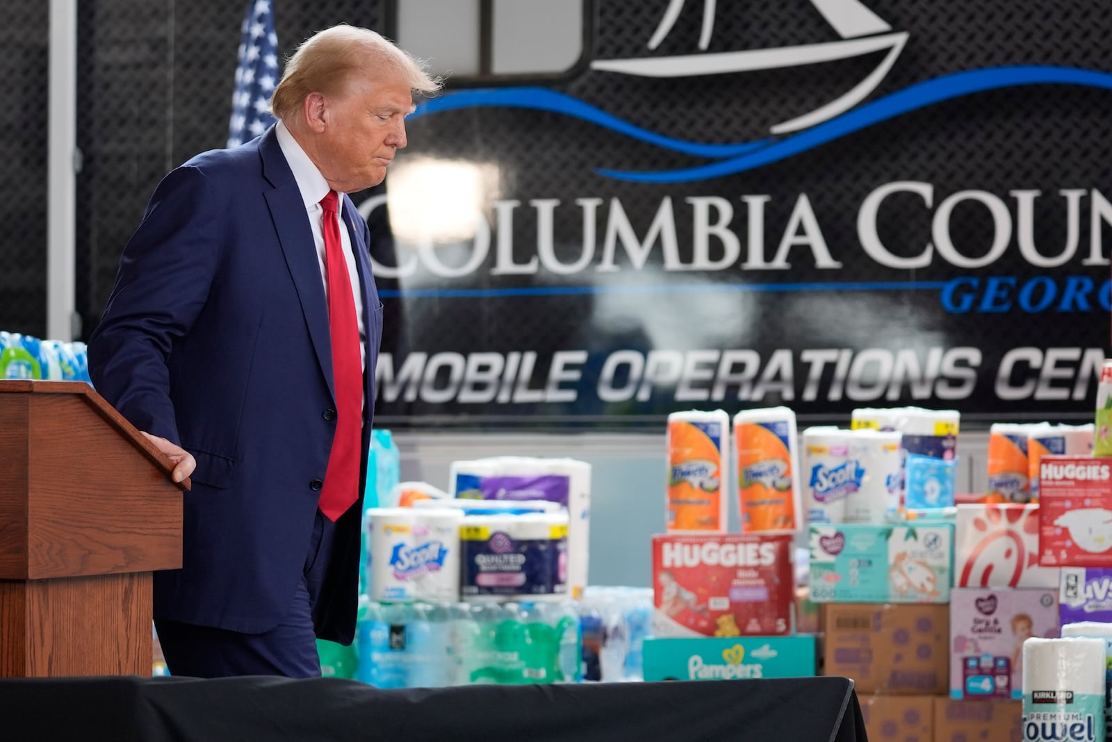 Republican presidential nominee former President Donald Trump walks from the podium after speaking at a temporary relief shelter as he visits areas impacted by Hurricane Helene, Friday, Oct. 4, 2024, in Evans, Ga. (AP Photo/Evan Vucci)