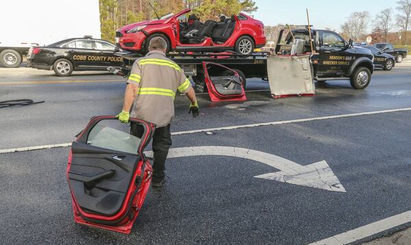 Cobb County police conduct their investigation where a crossing guard was hit and killed Thursday morning, Nov. 30, 2017 while directing traffic outside a Cobb County middle school. JOHN SPINK/JSPINK@AJC.COM