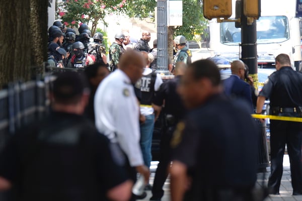 Several blocks of Peachtree Street are blocked Wednesday after an officer was shot at an apartment building. There is a heavy police presence in the area.