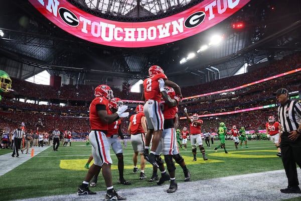 Georgia Bulldogs running back Kendall Milton (2) celebrates his eighteen-yard touchdown catch and run with offensive lineman Amarius Mims (65) during the fourth quarter against the Oregon Ducks in the Chick-fil-A Kickoff game at Mercedes Benz Stadium, Saturday, September 3, 2022, in Atlanta. Georgia won 49-3. (Jason Getz / Jason.Getz@ajc.com)