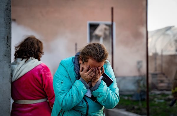 In this photo provided by the Ukrainian Emergency Service, a woman cries after her home was destroyed in a Russian missile attack in Odesa region, Ukraine, Sunday, Nov. 17, 2024. (Ukrainian Emergency Service via AP)