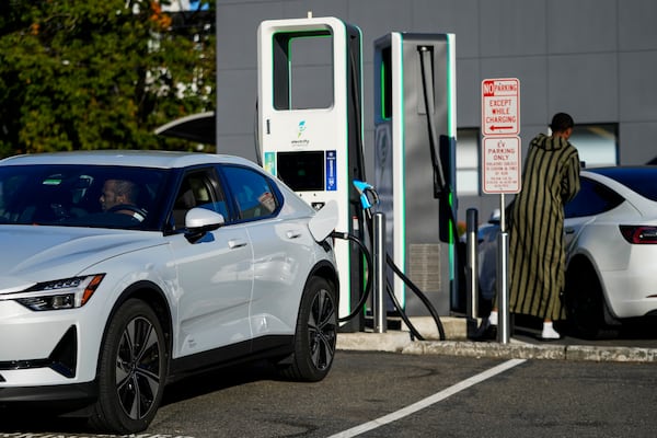 Drivers charge their electric vehicles at an Electrify America station, Wednesday, Oct. 9, 2024, in Seattle. (AP Photo/Lindsey Wasson)