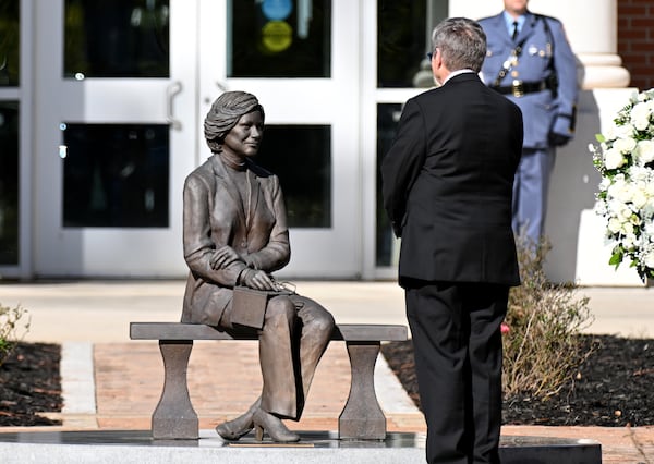 Chip Carter pauses by a statue of his mother during a wreath laying ceremony at the Rosalynn Carter Health & Human Services complex at Georgia Southwestern State University on Nov. 27, 2023, in Americus. (Hyosub Shin/AJC)