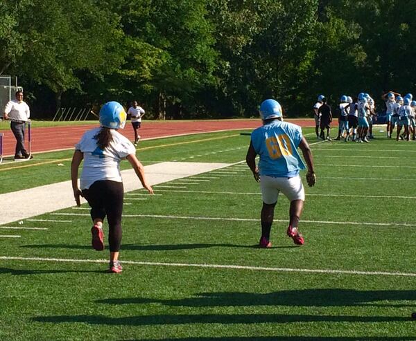 Atlanta School District Superintendent Meria Carstarphen pulls up lame during a high school football practice in 2017. Photo by Bill Torpy