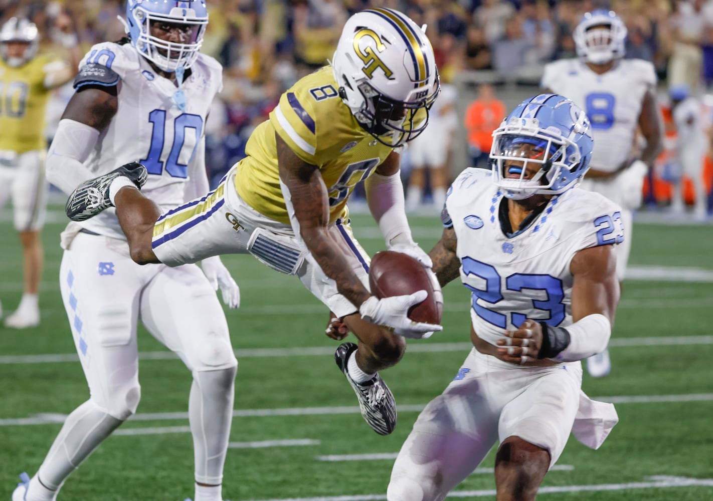 Georgia Tech Yellow Jackets wide receiver Malik Rutherford (8) leaps into the end zone for a touchdown during the second quarter of an NCAA football game In Atlanta on Saturday, Oct. 28, 2023 between the Georgia Tech Yellow Jackets and the North Carolina Tar Heels.  (Bob Andres for the Atlanta Journal Constitution)