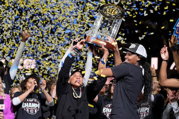 South Carolina head coach Dawn Staley holds the trophy with guard Bree Hall after their win against Texas in an NCAA college basketball game in the final of the Southeastern Conference tournament, Sunday, March 9, 2025, in Greenville, S.C. (AP Photo/Chris Carlson)