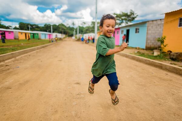 A boy runs down the street in a New Story housing development in Nuevo Cuscatlan, a community that's not far from El Salvador s capital, San Salvador. The nonprofit New Story has put on hold its plans to construct several hundred homes in Mexico, Haiti, and El Salvador due to safety concerns during the pandemic. Photo is courtesy of New Story.