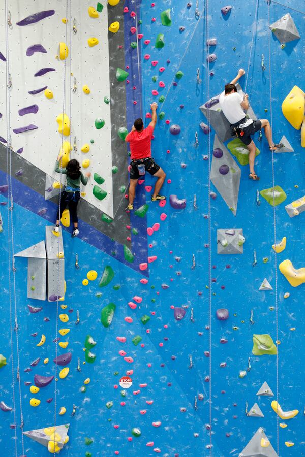 Participants ascend a climbing wall at Reach Climbing and Fitness in Bridgeport, Pa., on Wednesday, July 31, 2024. (AP Photo/Jonathan Elderfield)