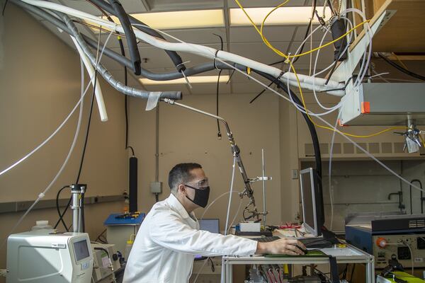 06/12/2020 - Atlanta , Georgia - Jean Carlos Rivera-Rios, who has a doctorate in Chemistry, checks particle composition on the Aerosol Mass Spectrometer at the Ford Environmental Science & Technology Building on the main campus of the Georgia Institute of Technology in Atlanta, Friday, June 12, 2020. Rivera-Rios is working to measure the air quality in Atlanta. (ALYSSA POINTER / ALYSSA.POINTER@AJC.COM)