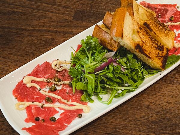 Beef carpaccio was tasty at Palm 78 but served under a huge mount of arugula and, strangely, with toast.