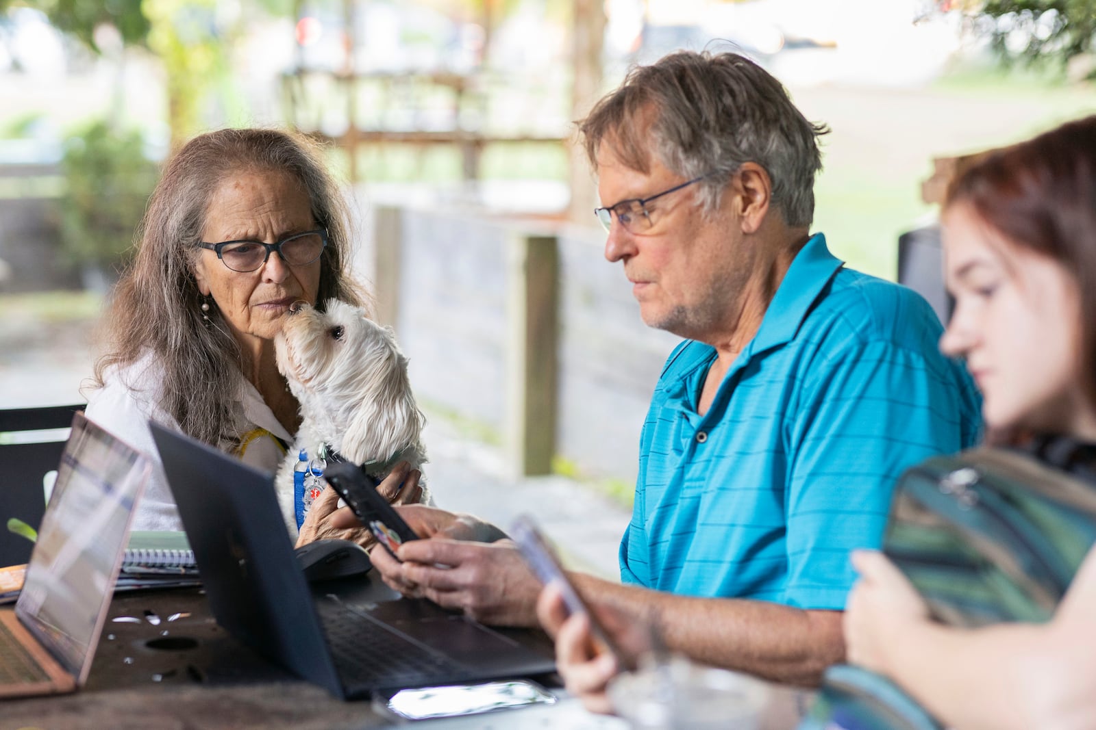 Patricia Sepulveda and Keith Fieldhammer send texts at IX Art Park in Charlottesville, Va., Thursday, Oct. 10, 2024. Charlottesville Democrats meet weekly to make phone calls, write postcards and send texts to get out the vote. (AP Photo/Ryan M. Kelly)