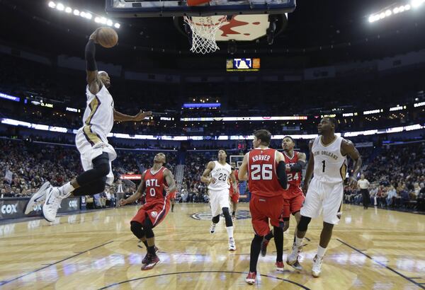 New Orleans Pelicans forward Dante Cunningham (44) slam dunks in the second half of an NBA basketball game against the Atlanta Hawks in New Orleans, Monday, Feb. 2, 2015. The Pelicans won 115-100. (AP Photo/Gerald Herbert)