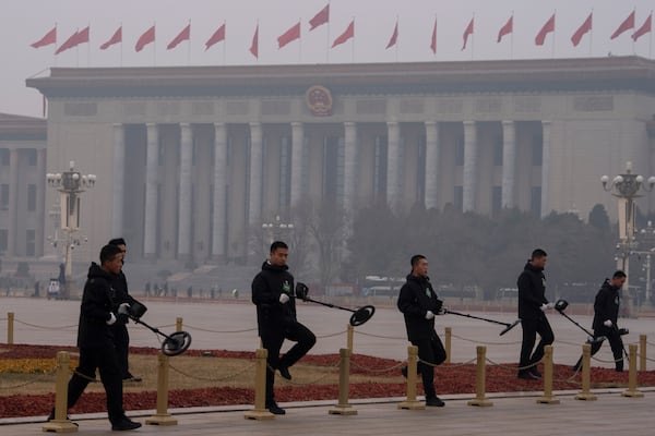 Members of the bomb squad sweep Tiananmen Square before the closing ceremony of the National People's Congress held at the Great Hall of the People in Beijing, Tuesday, March 11, 2025. (AP Photo/Ng Han Guan)