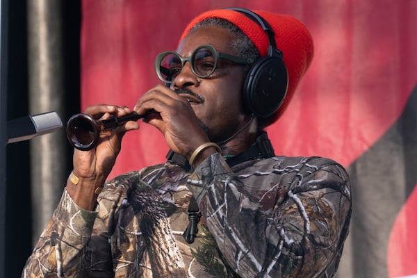 Andre 3000 plays flute onstage at the Atlanta Jazz Festival in May.