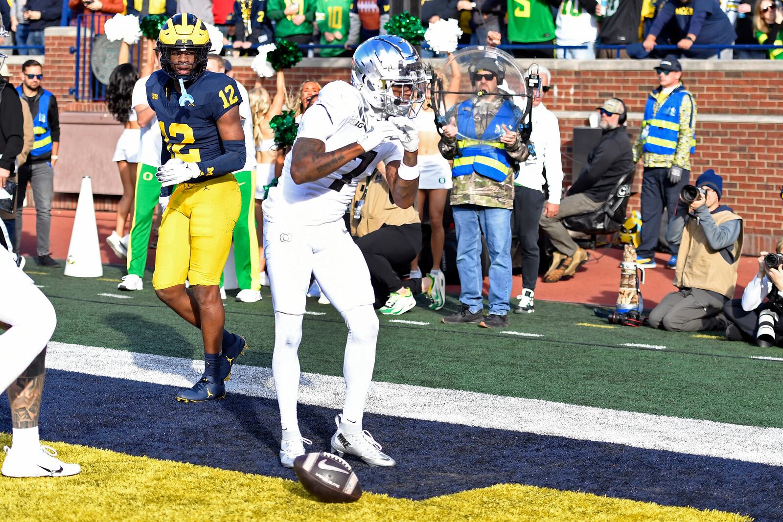 Oregon wide receiver Evan Stewart, right, reacts after scoring a touchdown as Michigan defensive back Aamir Hall looks on during the first half of an NCAA college football game, Saturday, Nov. 2, 2024, in Ann Arbor, Mich. (AP Photo/Jose Juarez)