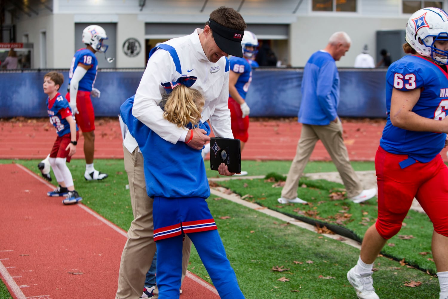 Daniel Brunner, head coach for Walton, hugs his daughter at halftime. CHRISTINA MATACOTTA FOR THE ATLANTA JOURNAL-CONSTITUTION.