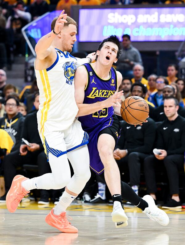 The Los Angeles Laker' Austin Reaves, right, drives to the basket against the Golden State Warrior' Donte DiVincenzo in the first half during Game 2 of the Western Conference Semifinals at Chase Center on Thursday, May 4, 2023, in San Francisco. (Wally Skalij/Los Angeles Times/TNS)