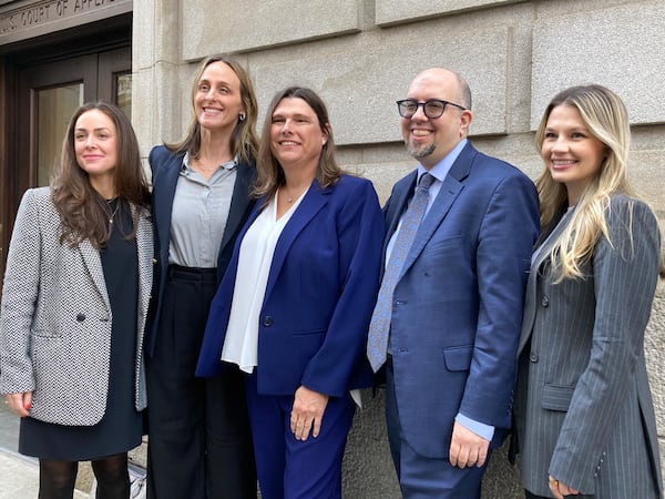 Houston County sheriff's deputy Anna Lange (center) and her lawyers pose for a photograph outside the 11th Circuit Court of Appeals in Atlanta on Tuesday, Feb. 4, 2025. (Rosie Manins/AJC)