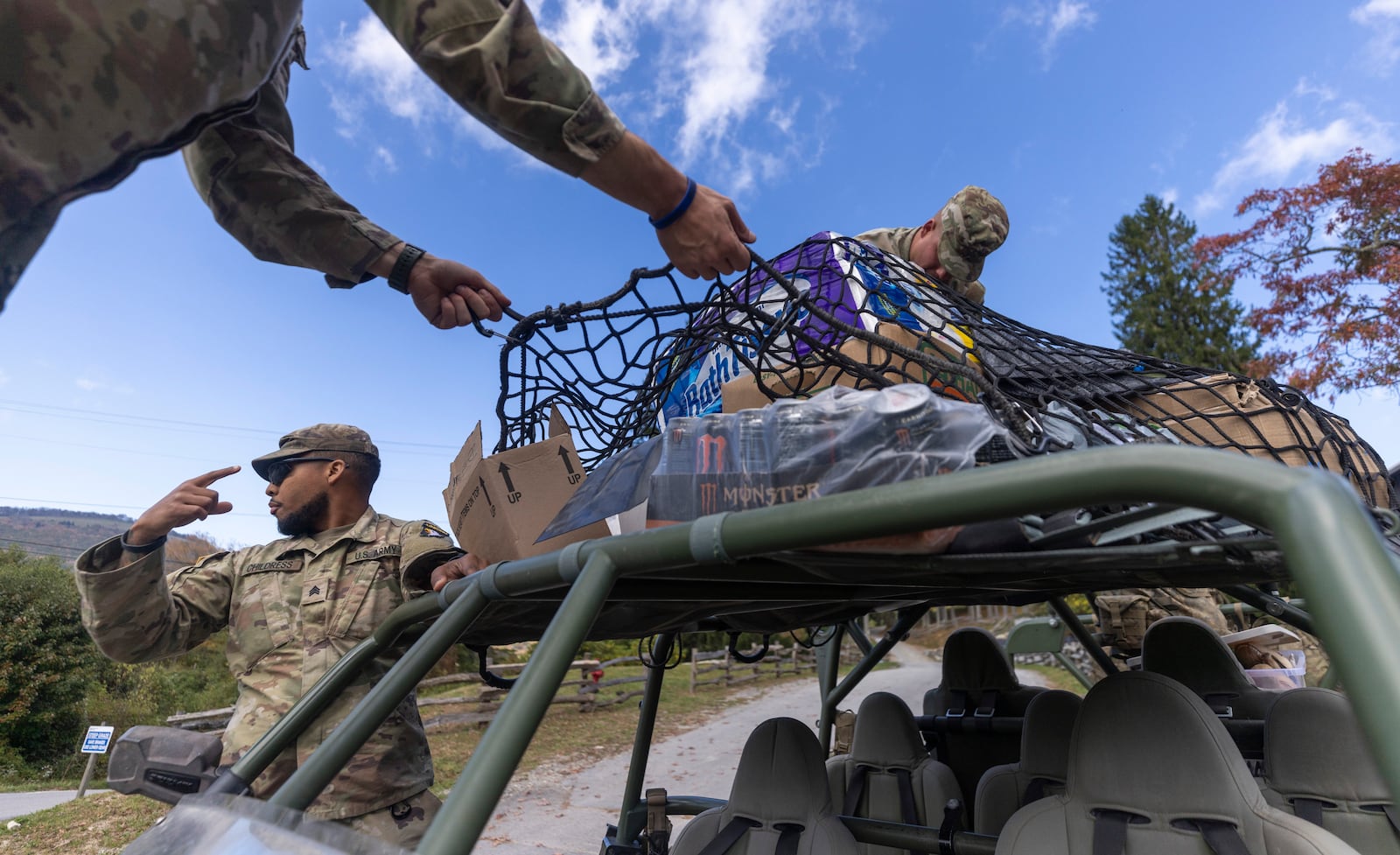 Soldiers with the 101st Airborne Division Air Assault, 2nd Brigade Combat Team, from Fort Campbell, Kentucky, use Infantry Squad Vehicles to deliver water, food, toiletries, and other aid to residents in the Soco Gap community in Maggie Valley on Tuesday, October. 8, 2024. The team has been using the Maggie Valley Pavilion and Town Hall as a distribution base for relief efforts in the town following Tropical Storm Helene. (Travis Long/The News & Observer via AP)