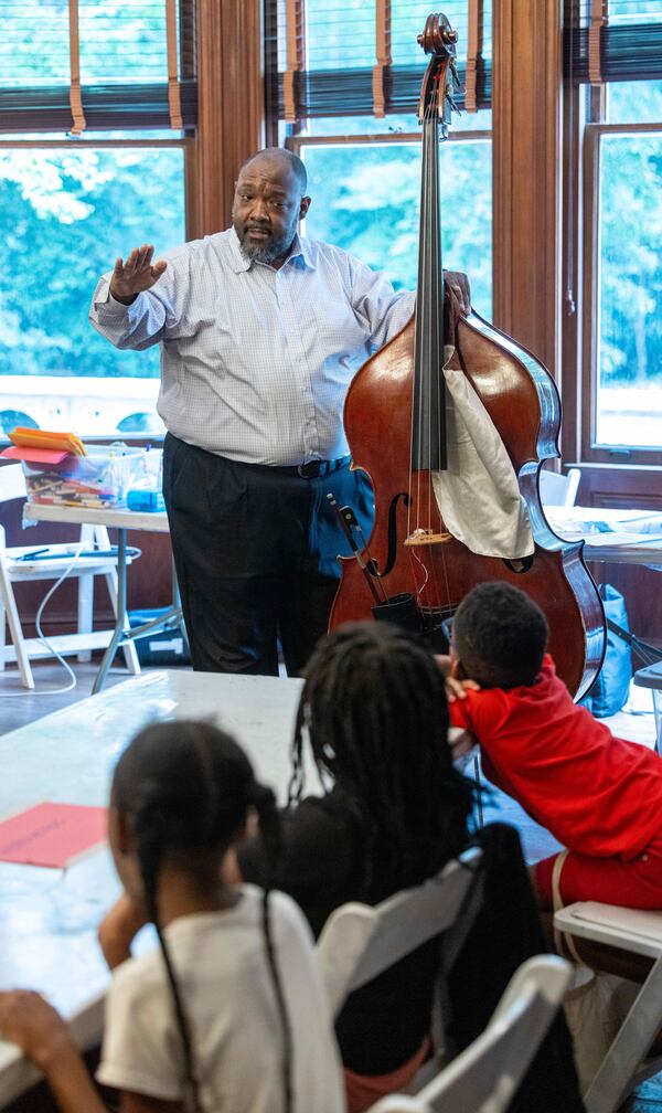 Bass player Kevin Smith teaches kids about his instrument at a summer camp at Callanwolde Fine Arts Center. PHIL SKINNER FOR THE ATLANTA JOURNAL-CONSTITUTION