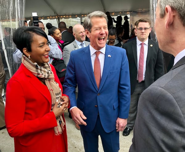 Atlanta Mayor Keisha Lance Bottoms and Gov. Brian Kemp chat before the Norfolk Southern groundbreaking. AJC/Scott Trubey.