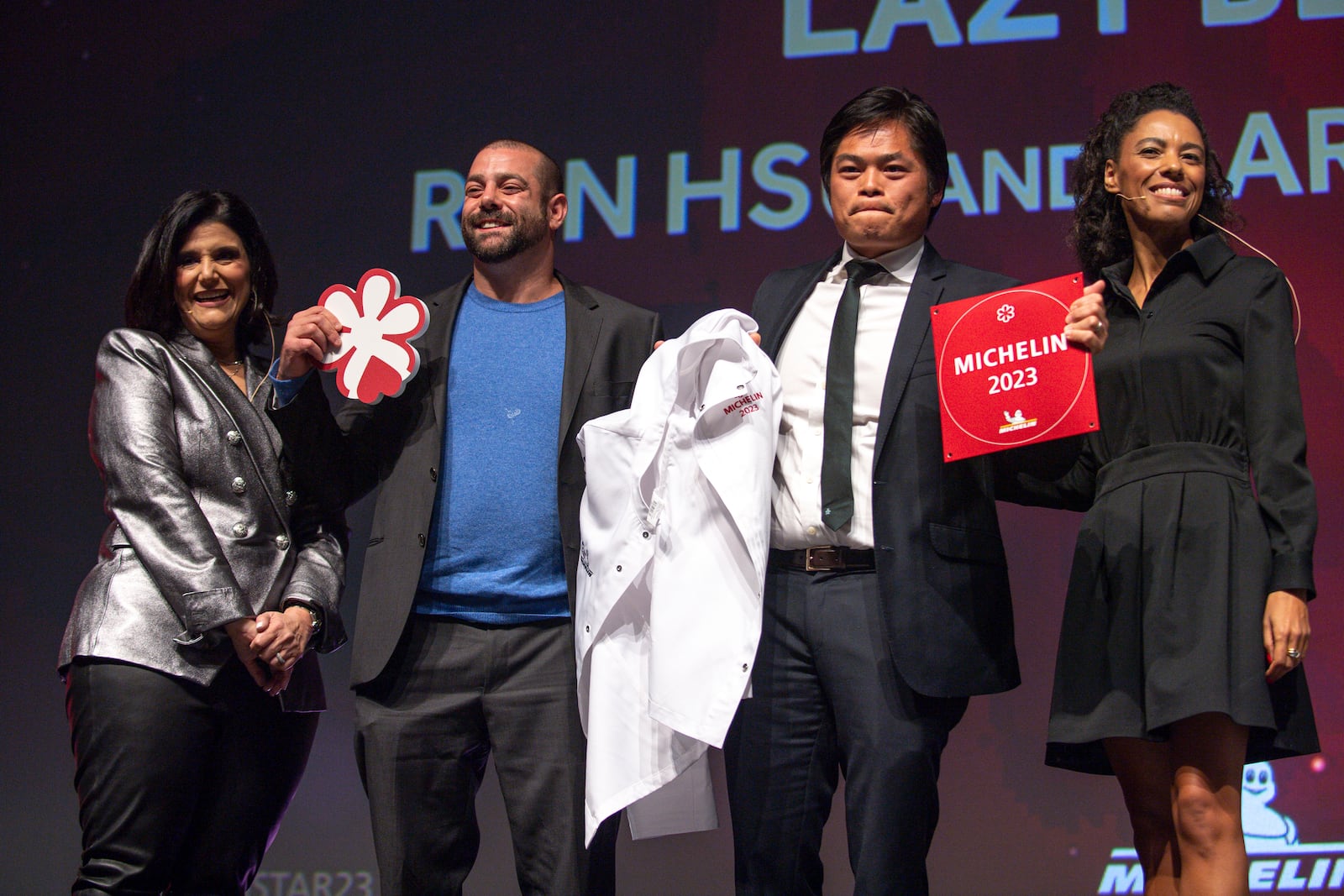 Event hosts Mara Davis (far left) and Elisabeth Boucher-Anselin (far right) are seen with Aaron Phillips (middle left) and Ron Hsu (middle right) of Michelin-starred restaurant Lazy Betty, during the Atlanta Michelin Guide gala ceremony Oct. 24, 2023 at the Rialto Center for the Arts in Atlanta. (Daniel Varnado for The Atlanta Journal-Constitution)