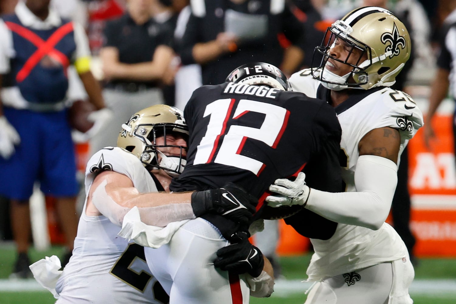 Falcons wide receiver KhaDarel Hodge tries to break free from Saints defenders during the second quarter Sunday at Mercedes-Benz Stadium. (Miguel Martinez / miguel.martinezjimenez@ajc.com)
