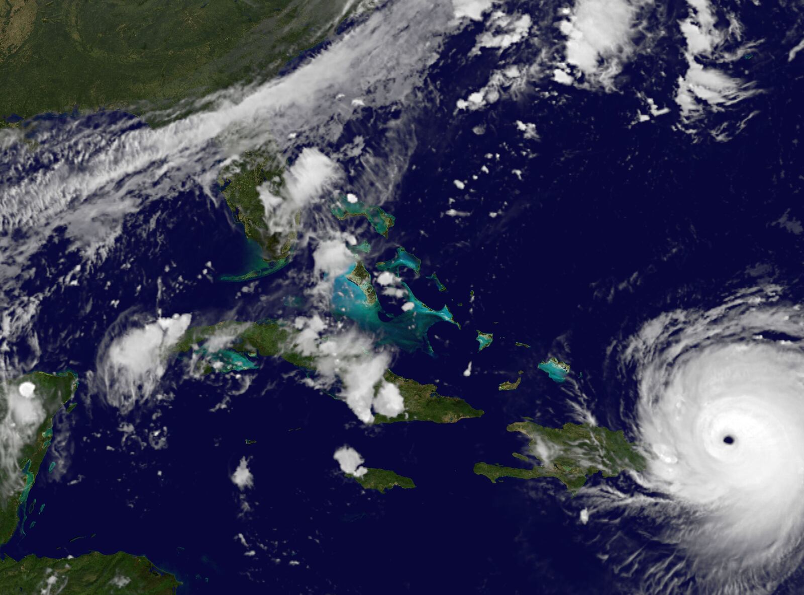 In this satellite image released by NASA/NOAA GOES Project, Hurricane Irma reaches Puerto Rico on Wednesday, Sept. 6, 2017. A decade-long lucky streak of decent weather that helped rescue one of Florida's biggest home insurers from collapse could come to a wet, violent end if predictions about Hurricane Irma prove true. (NASA/NOAA GOES Project via AP)