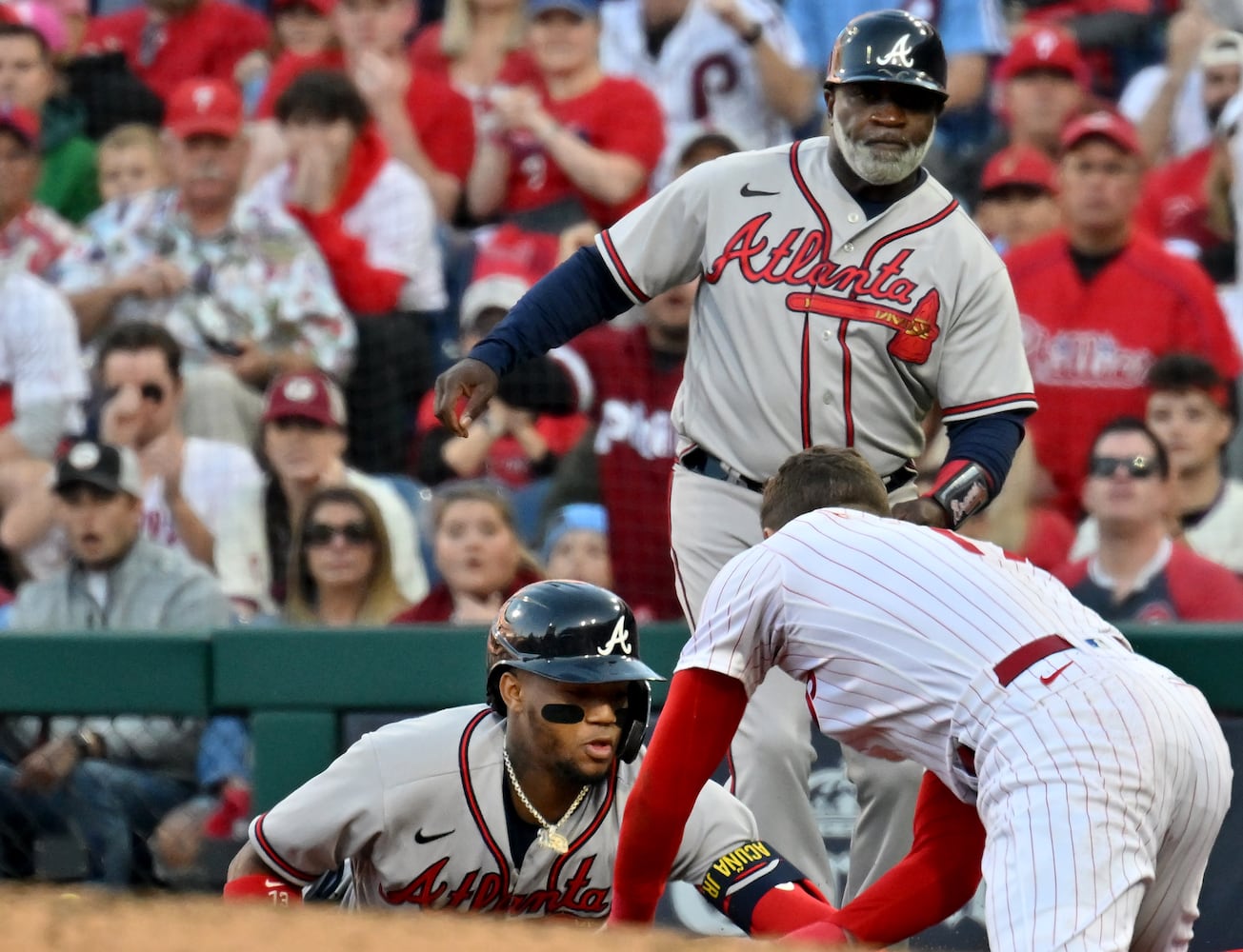 Atlanta Braves right fielder Ronald Acuna (13) is chased back to first base by Philadelphia Phillies first baseman Rhys Hoskins (17) after a single during the second inning of game three of the National League Division Series at Citizens Bank Park in Philadelphia on Friday, October 14, 2022. (Hyosub Shin / Hyosub.Shin@ajc.com)