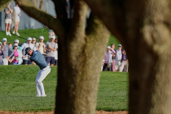 Justin Thomas hits his second shot on the 18th hole during the second round of The Players Championship golf tournament Friday, March 14, 2025, in Ponte Vedra Beach, Fla. (AP Photo/Chris O'Meara)