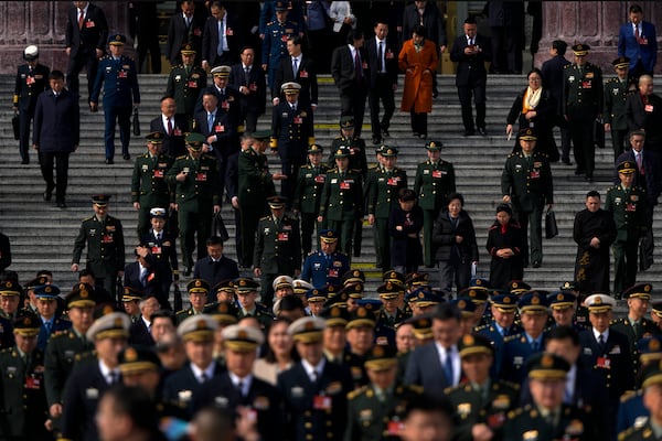 Military delegates leave the Great Hall of the People after attending a preparatory session of the National People's Congress in Beijing, Tuesday, March 4, 2025. (AP Photo/Andy Wong)