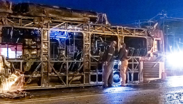 Atlanta fire officials inspect what is left of a MARTA bus that went up in flames early Monday morning. (John Spink / John.Spink@ajc.com)

