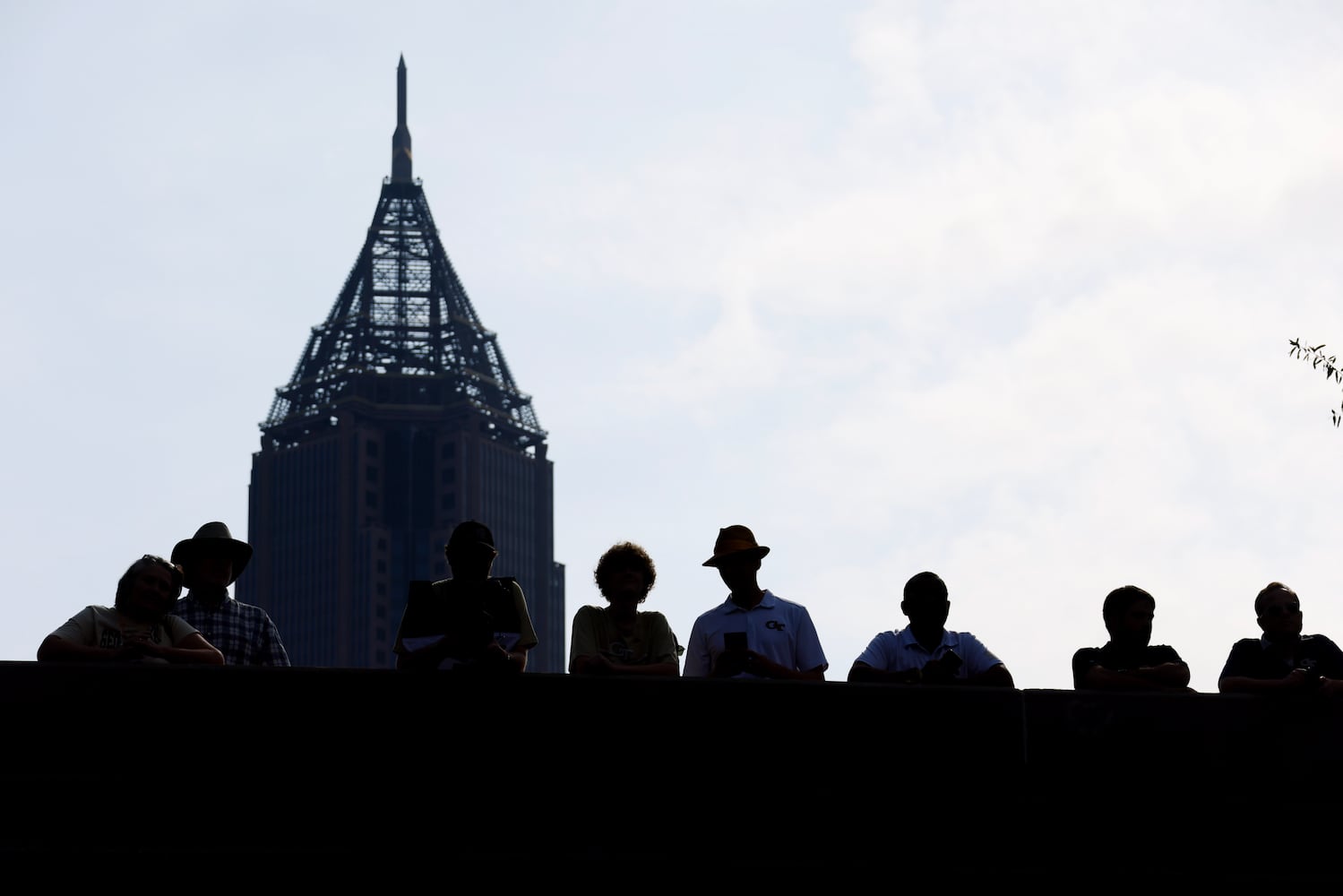 Fans line the bridge over North Avenue as they waif for the Yellow Jackets’ arrival to Bobby Dodd Stadium.  (Bob Andres for the Atlanta Journal Constitution)